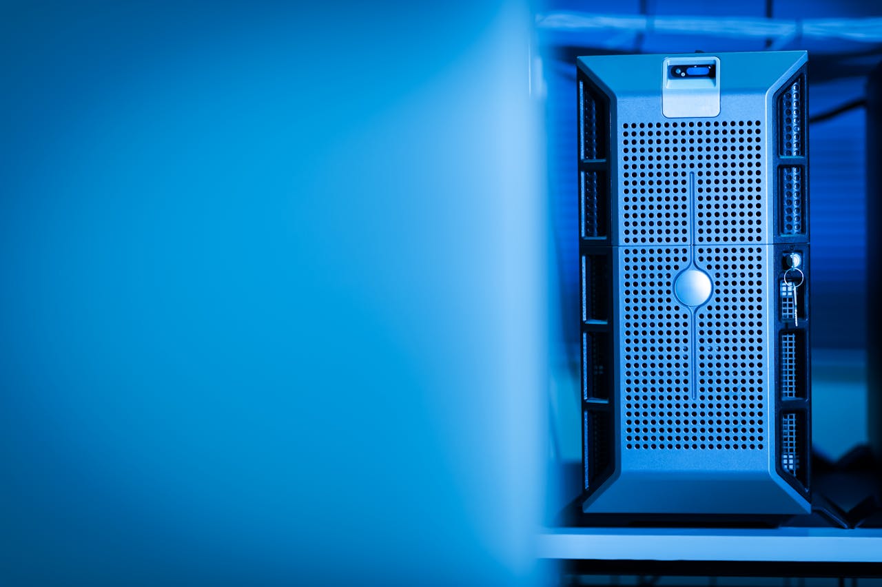 home-img Close-up of a modern server unit in a blue-lit data center environment.